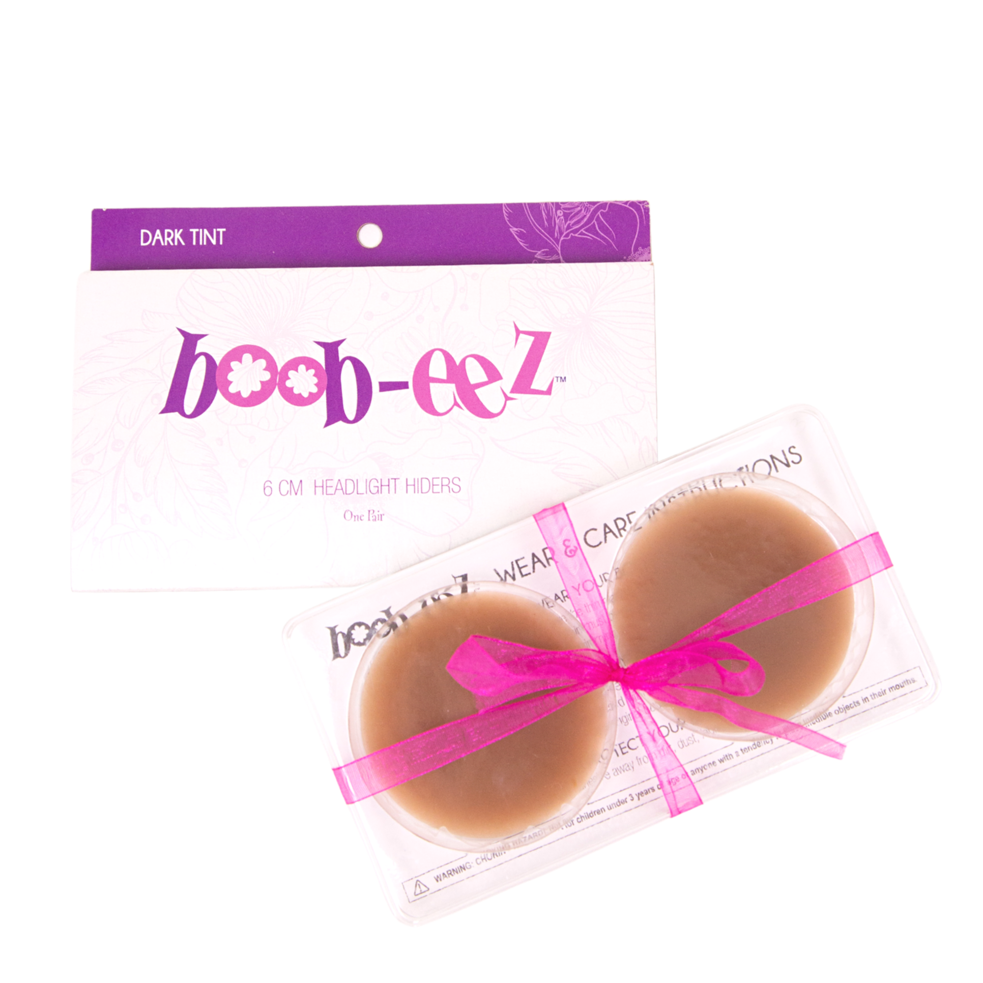 Product shot of reusable 6cm Dark tint Headlight Hiders in recycled craft packaging and an informative insert card with wear and care instructions and Boob-eez brand story