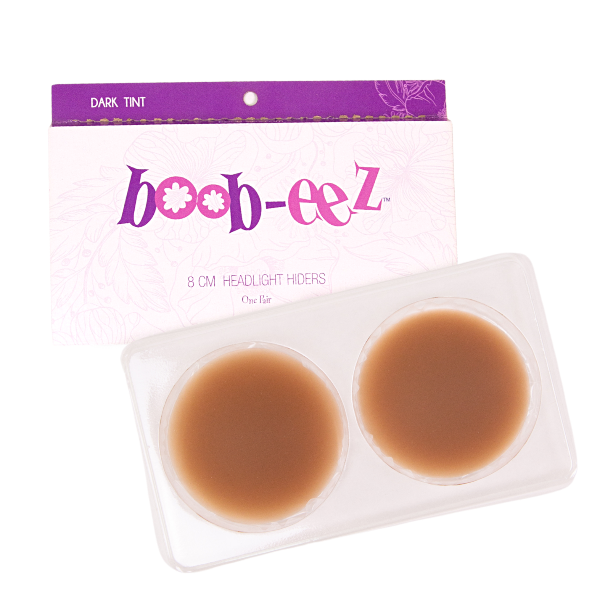 Product shot of the reusable 8cm Dark tint Headlight Hiders in recycled craft packaging and an informative insert cart with wear and care instructions and Boob-eez brand story