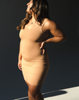 Product shot of NŪD Apparel Tayler Slip Dress, wide strap, fitted style and seamless, made of bamboo fabric produced in California, in Medium Nude on medium-skinned model, frontt/side shot