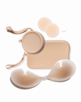 Product shot of sticky Light tint, Medium tint, and Dark tint 6cm Headlight Hiders and Silicone Stick-on Bra and durable Silicone Travel Cases in Light Nude, Medium Nude, and Dark Nude; information insert card with wear and care instructions, against a white background showing the thin edges of the Silicone Stick-on Bra
