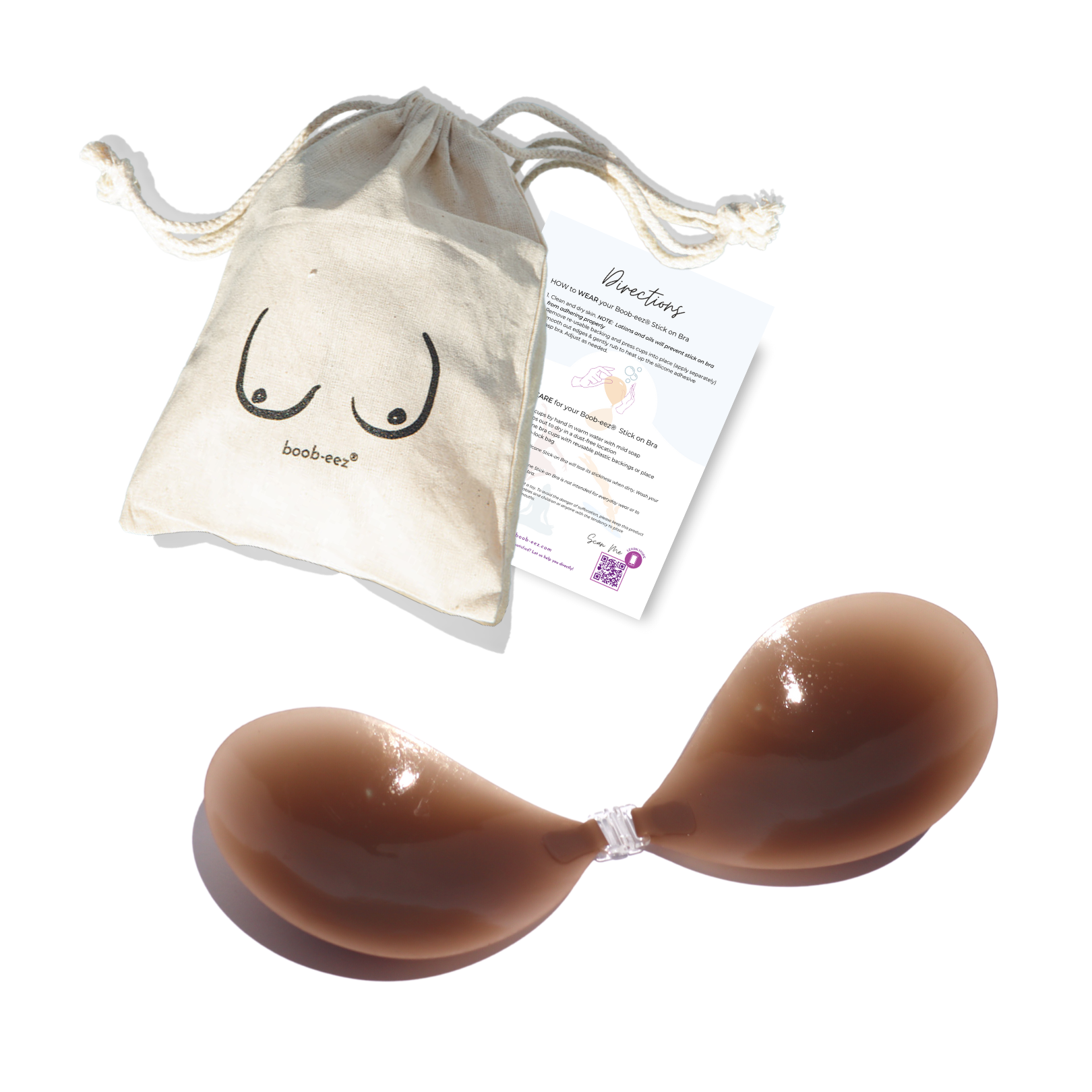 Product shot of a sticky Dark tint Silicone Stick-on Bra with a branded drawstring unbleached cotton muslin pouch and information insert card with wear and care instructions, close-up shot of clasp and thin edge of the Silicone Stick-on Bra