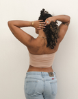 Product shot of NŪD Apparel Hunter Double-Layered Bandeau, strapless, cropped and seamless style, made of bamboo fabric produced in California, in Light Nude on medium-skinned model paired with light-wash jeans, back shot