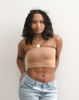 Product shot of NŪD Apparel Hunter Double-Layered Bandeau, strapless, cropped and seamless style, made of bamboo fabric produced in California, in Medium Nude on medium-skinned model paired with light-wash jeans, wide front shot