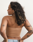 Product shot of NŪD Apparel Hunter Double-Layered Bandeau, strapless, cropped and seamless style, made of bamboo fabric produced in California, in Medium Nude on medium-skinned model paired with light-wash jeans, back shot