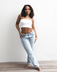 Product shot of NŪD Apparel Hunter Double-Layered Bandeau, strapless, cropped and seamless style, made of bamboo fabric produced in California, in White on medium-skinned model paired with light-wash jeans, front shot