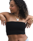 Product shot of NŪD Apparel Hunter Double-Layered Bandeau, strapless, cropped and seamless style, made of bamboo fabric produced in California, in Black on medium-skinned model paired with light-wash jeans, front shot