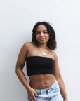 Product shot of NŪD Apparel Hunter Double-Layered Bandeau, strapless, cropped and seamless style, made of bamboo fabric produced in California, in Black on medium-skinned model paired with light-wash jeans, front shot