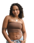 Product shot of NŪD Apparel Hunter Double-Layered Bandeau, strapless, cropped and seamless style, made of bamboo fabric produced in California, in Dark Nude on medium-skinned model paired with light-wash jeans, front shot
