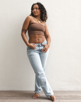 Product shot of NŪD Apparel Hunter Double-Layered Bandeau, strapless, cropped and seamless style, made of bamboo fabric produced in California, in Dark Nude on medium-skinned model paired with light-wash jeans, front wide shot