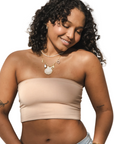 Product shot of NŪD Apparel Hunter Double-Layered Bandeau, strapless, cropped and seamless style, made of bamboo fabric produced in California, in Light Nude on medium-skinned model paired with light-wash jeans