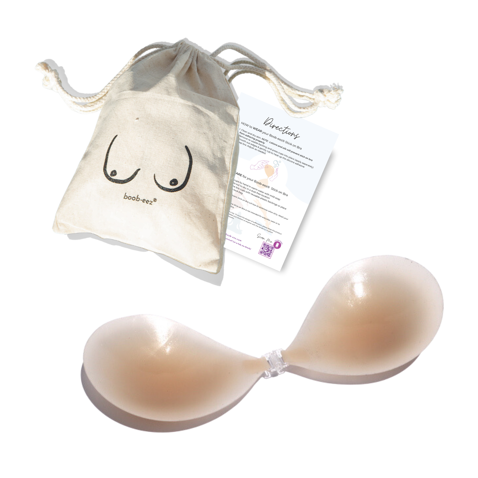 Product shot of a reusable and sticky Light tint Silicone Stick-on Bra with Boob-eez branded drawstring unbleached cotton muslin pouch and information insert card with wear and care instructions against a white background, showing the thin edges of the Silicone tick-on Bra