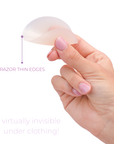 Product shot of hand holding a flexible and reusable Light tint Headlight Hider showing the razor thin edge, explaining the Headlight Hiders are invisible underneath clothing because of the thin edge