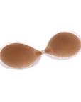 Product shot of reusable and sticky Medium tint Silicone Stick-on Bra laying flat on white background showing the razor thin edge of the Silicone Stick-on Bra