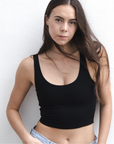 Product shot of NŪD Apparel Devon Double Layered Scoop Crop top, wide strap and seamless, made of bamboo fabric produced in California, in Black on fair-skinned model paired with light-wash jeans, front close-up shot