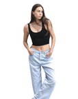 Product shot of NŪD Apparel Devon Double Layered Scoop Crop top, wide strap and seamless, made of bamboo fabric produced in California, in Black on fair-skinned model paired with light-wash jeans, front wide shot