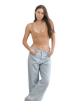 Product shot of NŪD Apparel Devon Double Layered Scoop Crop top, wide strap and seamless, made of bamboo fabric produced in California, in Medium Nude on fair-skinned model paired with light-wash jeans, front wide shot