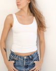Product shot NŪD Apparel Devon Long Double Layer Scoop, wide strap, perfect length and seamless, made of bamboo fabric produced in California, in White on fair-skinned model paired with light-wash jeans, front shot