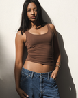 Product shot NŪD Apparel Devon Long Double Layer Scoop, wide strap, perfect length and seamless, made of bamboo fabric produced in California, in Dark Nude on medium-skinned model paired with dark-wash jeans, front shot