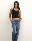 Product shot NŪD Apparel Devon Long Double Layer Scoop, wide strap, perfect length and seamless, made of bamboo fabric produced in California, in Black on medium-skinned model paired with dark-wash jeans, front wide shot