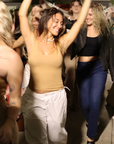 Product shot NŪD Apparel Devon Long Double Layer Scoop, wide strap, perfect length and seamless, made of bamboo fabric produced in California, in Medium Nude on medium-skinned model paired with white cargo pants, front shot