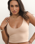Product shot of NŪD Apparel Kyla Double Layered Crop top, thin strap and seamless, made of bamboo fabric produced in California, in Light Nude on medium-skinned model, front close-up shot