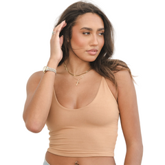 Product shot of NŪD Apparel Kyla Double Layered Crop top, thin strap and seamless, made of bamboo fabric produced in California, in Medium Nude on medium-skinned model paired with light-wash jeans, front shot