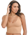Product shot of NŪD Apparel Kyla Double Layered Crop top, thin strap and seamless, made of bamboo fabric produced in California, in Medium Nude on medium-skinned model paired with light-wash jeans, front shot