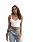 Product shot of NŪD Apparel Kyla Double Layered Crop top, thin strap and seamless, made of bamboo fabric produced in California, in White on medium-skinned model paired with light-wash jeans, front wide shot