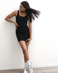 Product shot of NŪD Apparel Tayler Slip Dress, wide strap, fitted style and seamless, made of bamboo fabric produced in California, in Black on medium-skinned model, front shot
