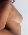 Product shot of Medium tint Silicone Stick-on Bra size B-cup on medium-skinned model, close-up side shot of Silicone Stick-on Bra showing the razor thin edge and natural look without adding extra bulk