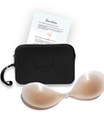 Product shot of sticky Light tint Silicone Stick-on Bra and durable Silicone Travel Case for Silicone Stick-on Bras in Black and information insert card with wear and care instructions, against a white background showing the thin edges of the Silicone Stick-on Bra