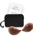 Product shot of sticky Dark tint Silicone Stick-on Bra and durable Silicone Travel Case for Silicone Stick-on Bras in Black and information insert card with wear and care instructions, against a white background showing the thin edges of the Silicone Stick-on Bra