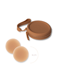 Product shot of reusable Medium tint 6cm Headlight Hiders and Silicone Travel Case for sticky Headlight Hiders in Medium Nude with a removable strap and zipper detail, against a white background showing the thin edges of the Headlight Hiders