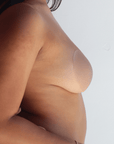 Product shot of Medium tint Silicone Stick-on Bra size B-cup on medium-skinned model, close-up side shot of Silicone Stick-on Bra showing the razor thin edge and natural look without adding extra bulk