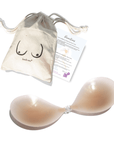 Product shot of a reusable and sticky Light tint Silicone Stick-on Bra with Boob-eez branded drawstring unbleached cotton muslin pouch and information insert card with wear and care instructions against a white background, showing the thin edges of the Silicone tick-on Bra