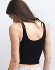 Product shot of NŪD Apparel Devon Double Layered Scoop Crop top, wide strap and seamless, made of bamboo fabric produced in California, in Black on fair-skinned model paired with light-wash jeans, back shot
