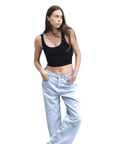 Product shot of NŪD Apparel Devon Double Layered Scoop Crop top, wide strap and seamless, made of bamboo fabric produced in California, in Black on fair-skinned model paired with light-wash jeans, front wide shot