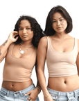 Product shot of NŪD Apparel Devon Double Layered Scoop Crop top, wide strap and seamless, made of bamboo fabric produced in California, in Medium Nude on medium-skinned model and Light Nude on fair-skinned model paired with light-wash jeans, front shot