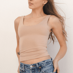 Product shot NŪD Apparel Devon Long Double Layer Scoop, wide strap, perfect length and seamless, made of bamboo fabric produced in California, in Light Nude on fair-skinned model paired with light-wash jeans, front shot