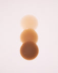 Product shot of Boob-eez Headlight Hiders, showing the razor thin edges and skin tint difference between the Headlight Hiders