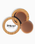 Product shot of Boob-eez Bamboo Compact with 6cm Dark tint Headlight Hiders inside and informative insert cards with wear and care instructions, close-up shot showing how to open and close the Bamboo Compact