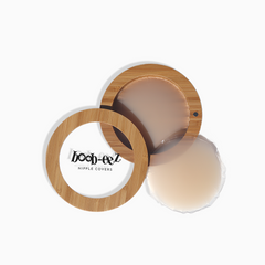 Product shot of Boob-eez Bamboo Compact with 6cm Light tint Headlight Hiders inside and informative insert cards with wear and care instructions, close-up shot showing how to open and close the Bamboo Compact