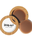 Product shot of Boob-eez Bamboo Compact with 8cm Dark tint Headlight Hiders inside and informative insert cards with wear and care instructions, close-up shot showing how to open and close the Bamboo Compact
