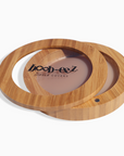 Product shot of the Boob-eez Bamboo Compact with Medium tint Headlight Hiders inside, close-up side shot showing the beautiful wood grain, magnetic closure, and translucent window to display the Headlight Hiders inside