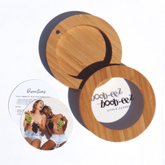 Product shot of the Boob-eez Bamboo Compact Case and informative insert cards with wear and care instructions, close-up front shot showing the beautiful wood grain, magnetic closure, and translucent window to display your Headlight Hiders