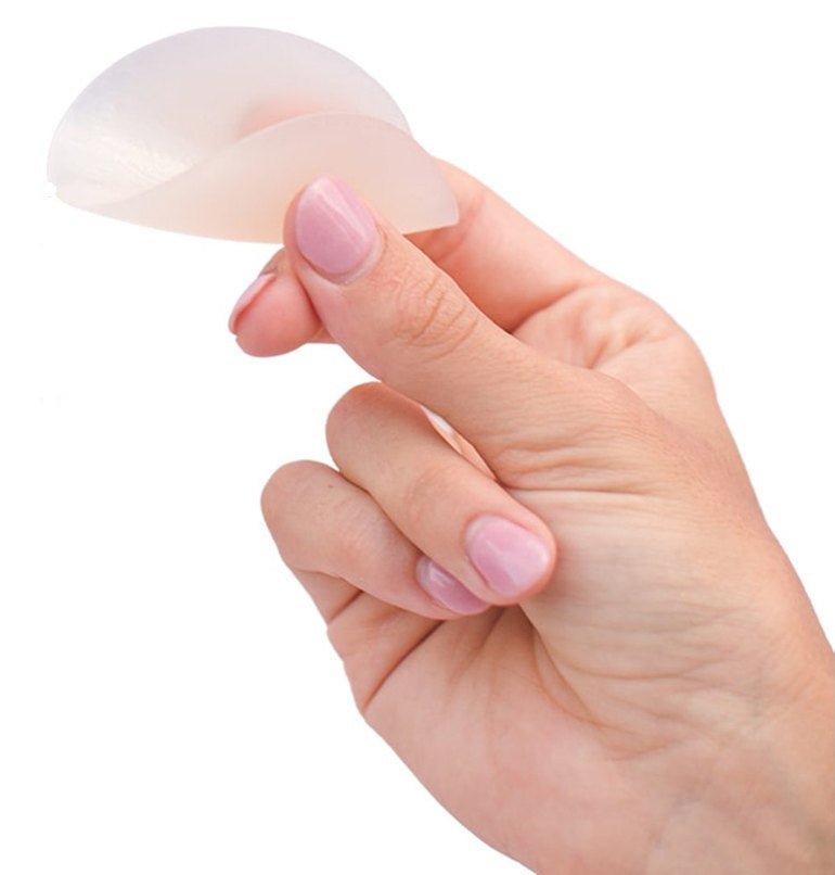 Boob-eez silicone nipple cover held between fingers