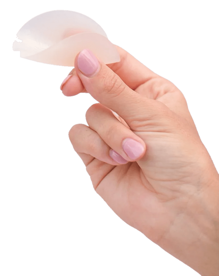 Hand holding an ultra-thin Boob-eez silicone cover