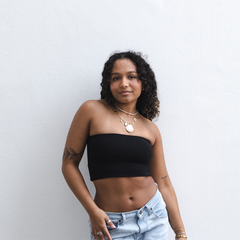 Product shot of NŪD Apparel Hunter Double-Layered Bandeau, strapless, cropped and seamless style, made of bamboo fabric produced in California, in Black on medium-skinned model paired with light-wash jeans, front shot