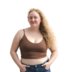 Product shot of NŪD Apparel Kyla Double Layered Crop top, thin strap and seamless, made of bamboo fabric produced in California, in Dark Nude on fair-skinned model paired with dark-wash jeans, front shot