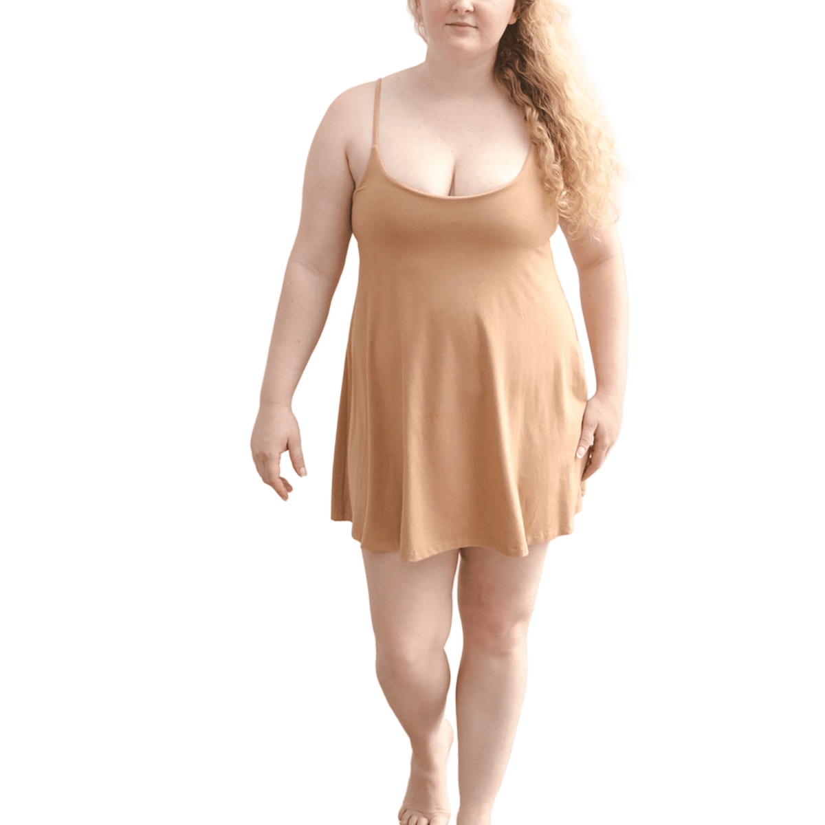 Product shot of NŪD Apparel Betty Swinging Slip Dress, thin adjustable strap, loose style and with shelf bra, made of bamboo fabric produced in California, in Medium Nude on fair-skinned model, front shot